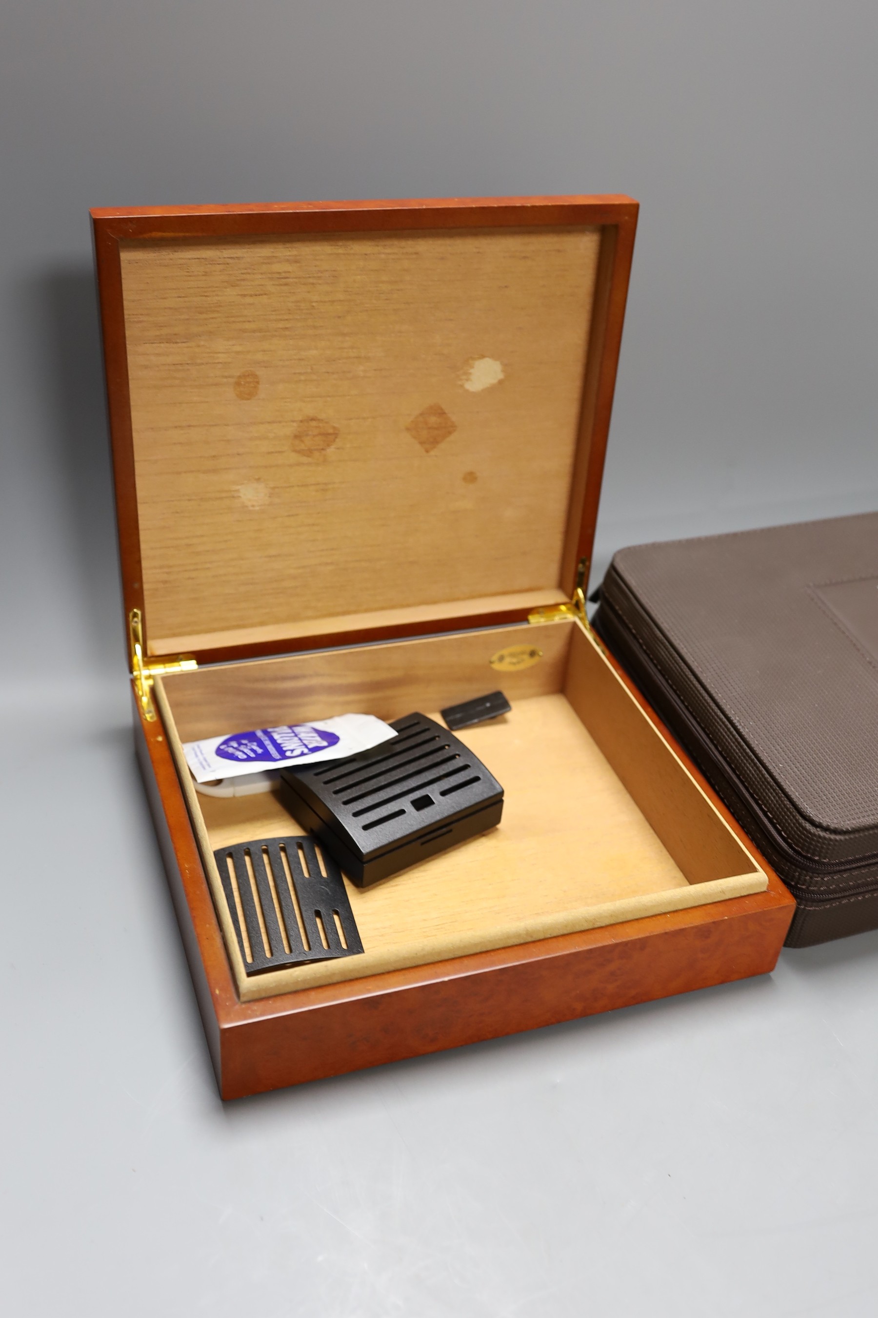 A Montecristo cigar humidor and another faux walnut humidor